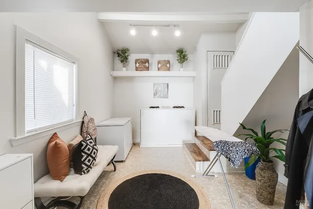 a view of a patio with couches table and chairs and potted plants