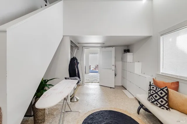 a backyard of a house with barbeque oven and table