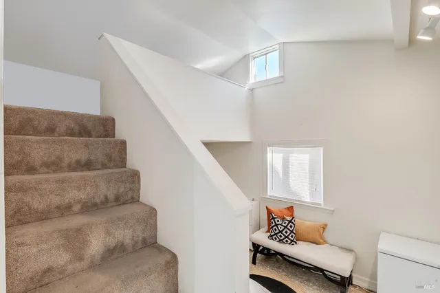 an aerial view of residential houses with outdoor space and parking