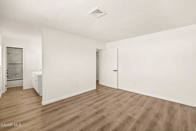 a view of a room with wooden floor
