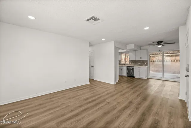 a view of a kitchen with a dishwasher and a refrigerator
