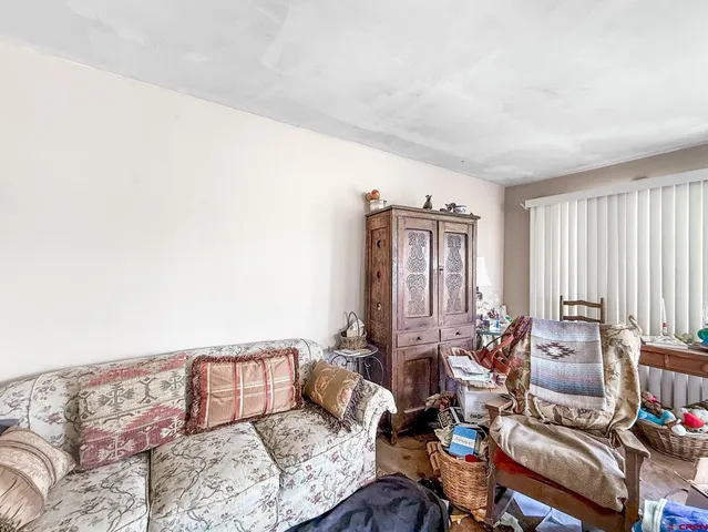 a bed room with furniture and a window