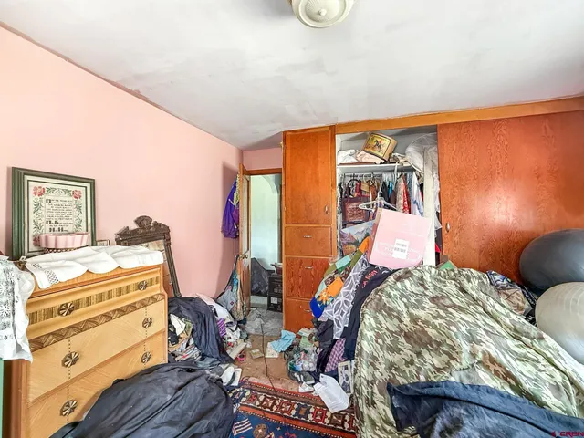 a bedroom with furniture and a dresser