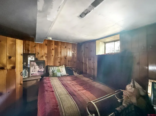 a bedroom with a large bed and a chandelier