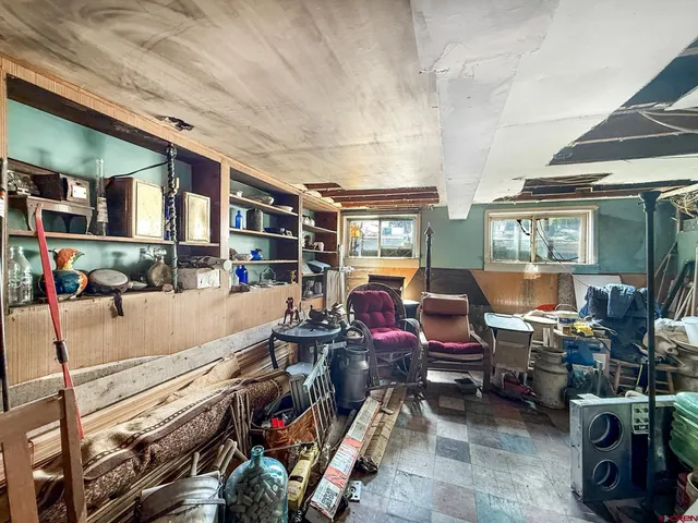 a living room with lots of furniture and a large window