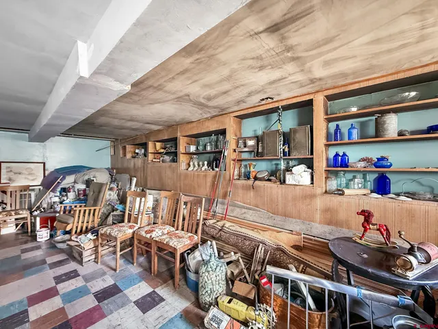 a living room with lots of furniture and baby toys