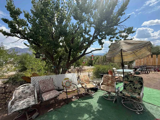 a view of a backyard with swimming pool