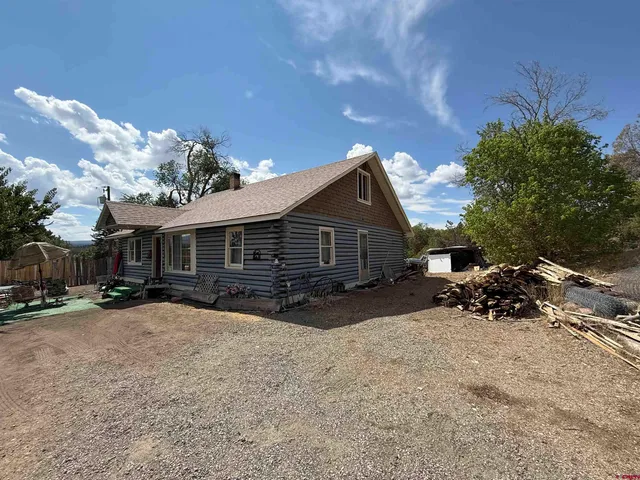 a view of a house with a yard covered in snow