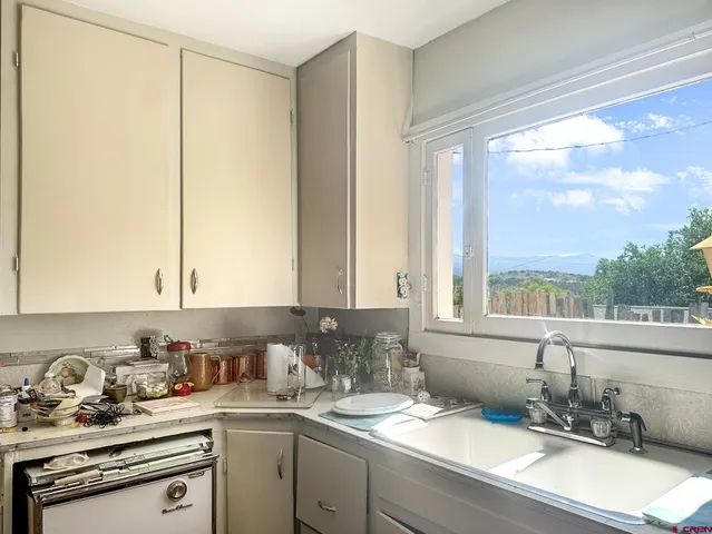 a kitchen with a sink cabinets and window