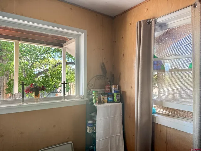 a room with refrigerator and window