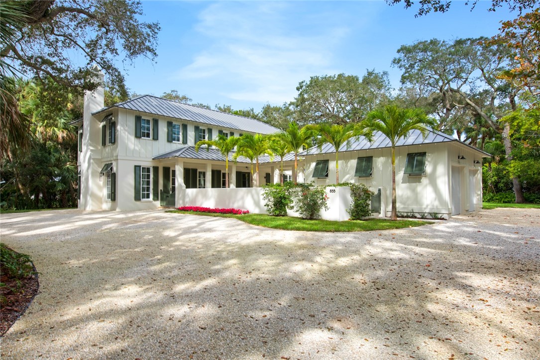 855 Sandfly Lane Vero Beach, FL 32963 - Photo 1 of 35 a front view of a house with a yard and trees