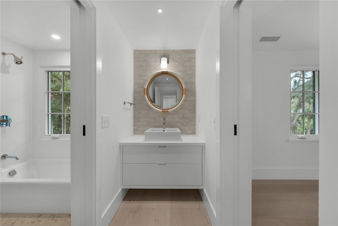 855 Sandfly Lane Vero Beach, FL 32963 - Photo 24 of 35 a bathroom with a sink a toilet and a bathtub