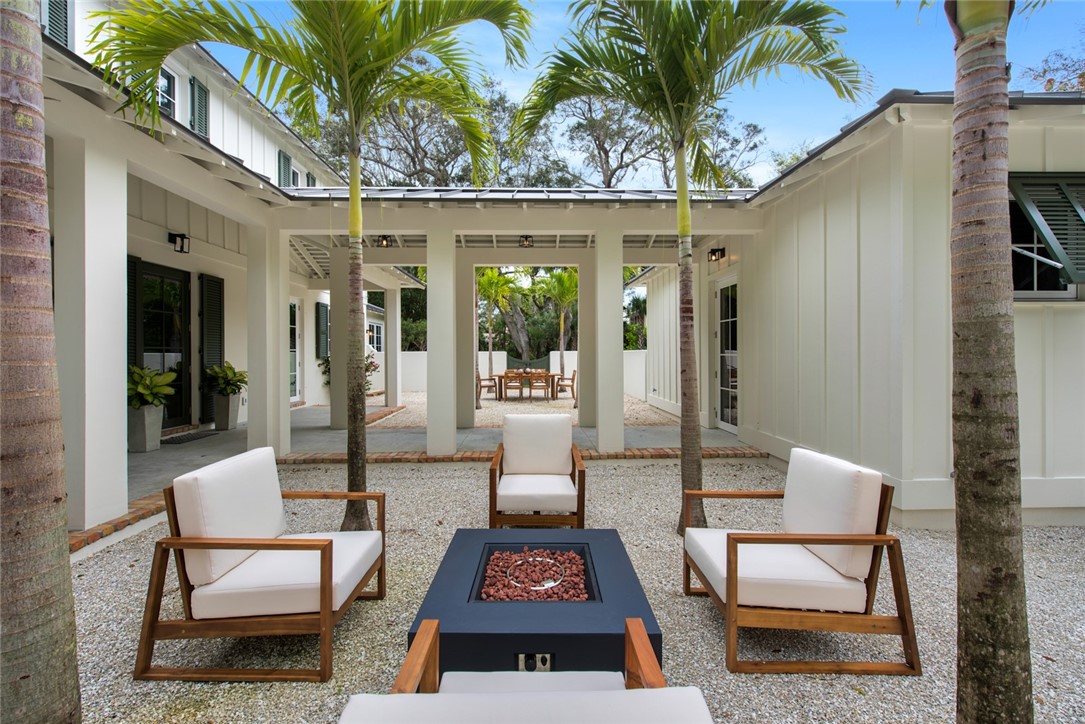 855 Sandfly Lane Vero Beach, FL 32963 - Photo 30 of 35 a view of a patio with a dining table and chairs