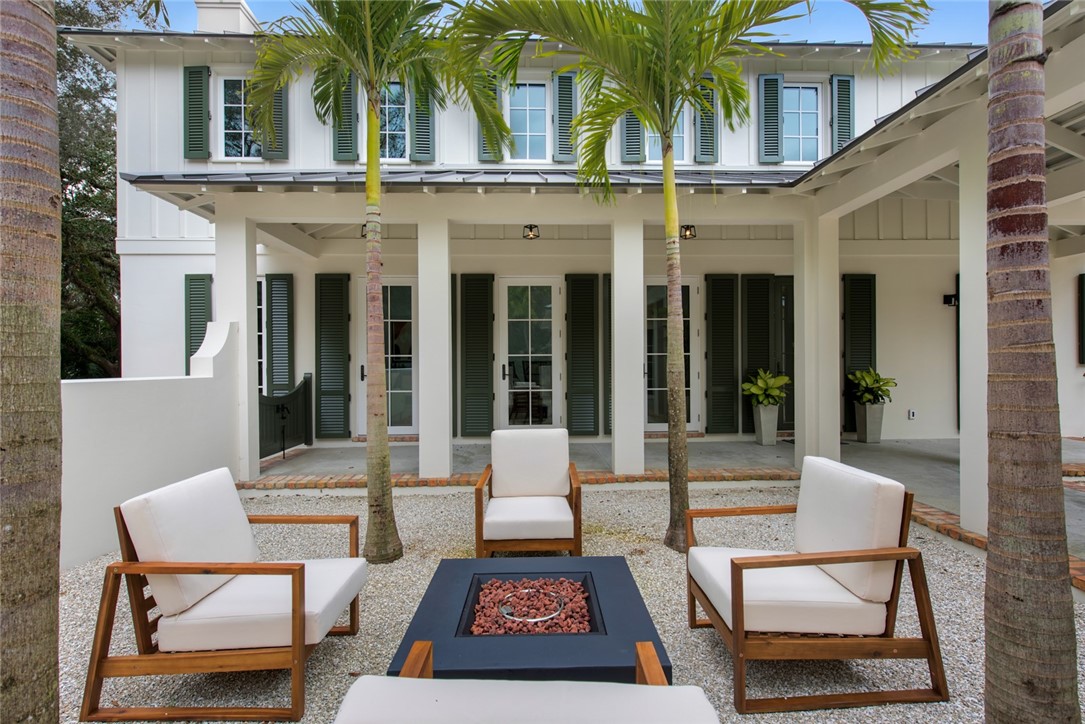 855 Sandfly Lane Vero Beach, FL 32963 - Photo 32 of 35 a view of a patio with couches table and chairs and potted plants