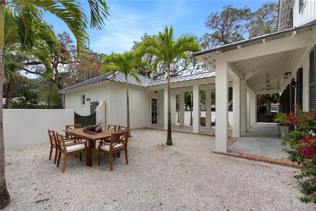 855 Sandfly Lane Vero Beach, FL 32963 - Photo 33 of 35 a patio with a table and chairs and potted plants