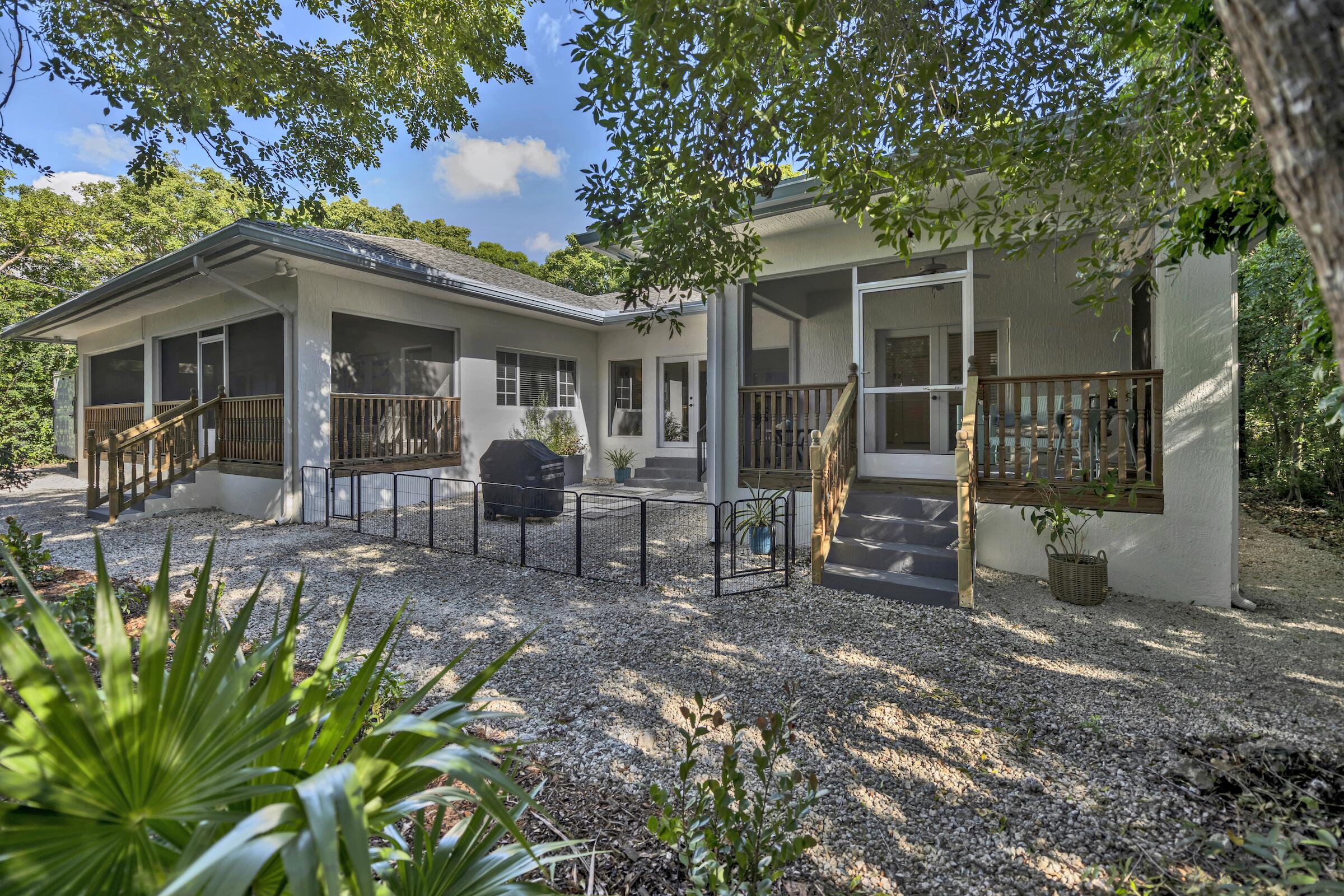 a view of a house with backyard porch and sitting area
