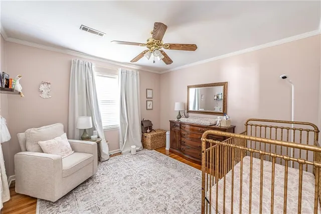 a bedroom with furniture and wooden floor