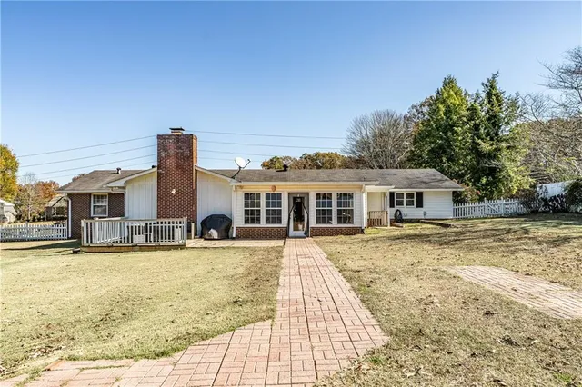 a view of a house with pool and sitting area