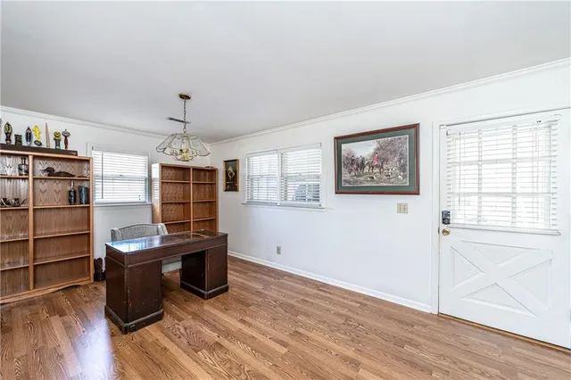 a view of a workspace with furniture and wooden floor