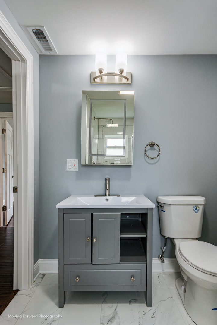 473 East Elm Street Sycamore, IL 60178 - Photo 15 of 53 a bathroom with a toilet sink and mirror