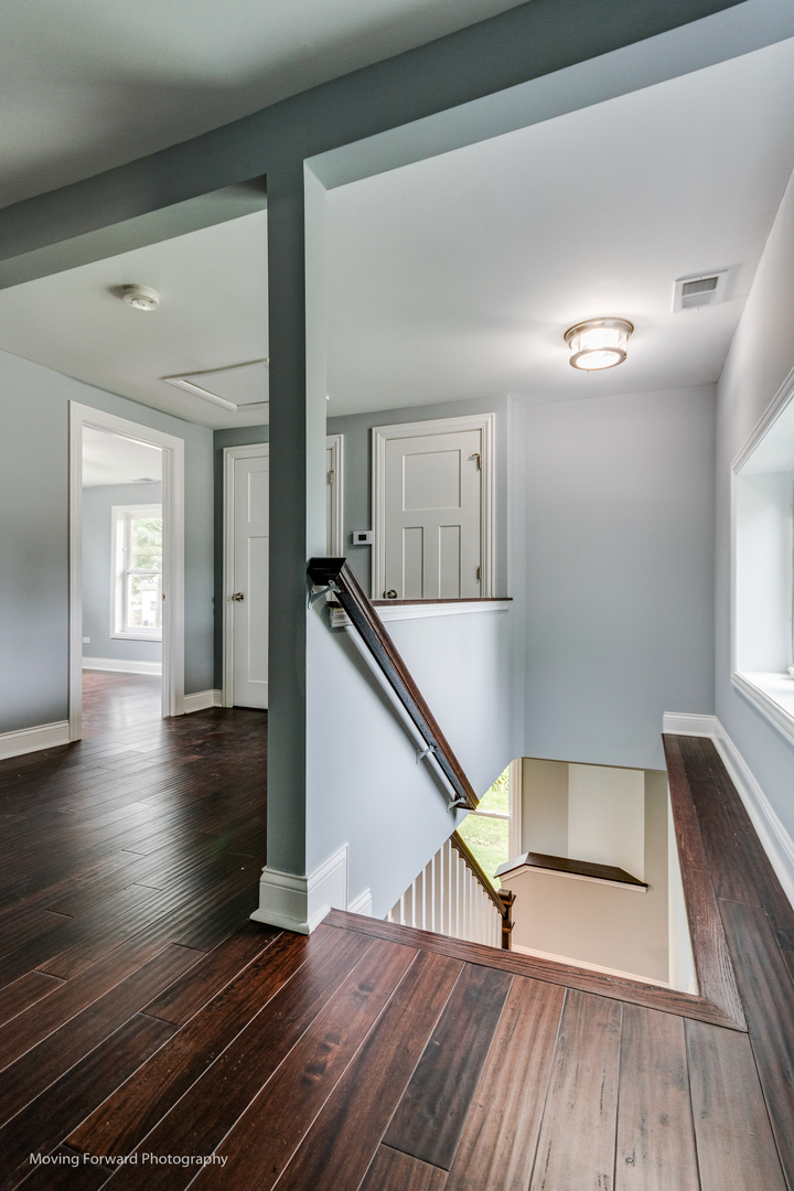473 East Elm Street Sycamore, IL 60178 - Photo 25 of 53 a view of a hallway with wooden floor and staircase