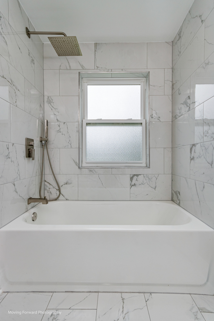 473 East Elm Street Sycamore, IL 60178 - Photo 26 of 53 a bathroom with a bathtub and a shower