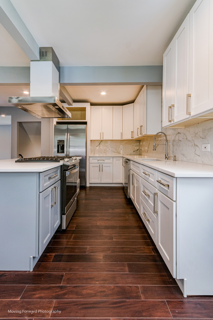 473 East Elm Street Sycamore, IL 60178 - Photo 45 of 53 a large kitchen with cabinets and wooden floor