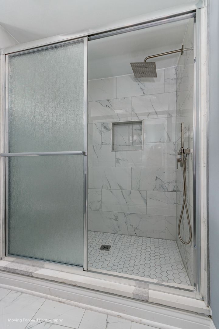473 East Elm Street Sycamore, IL 60178 - Photo 48 of 53 a bathroom with a glass shower door