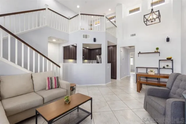 a living room with furniture and kitchen view
