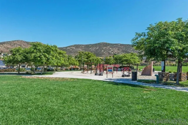 a view of a garden with a house in the background