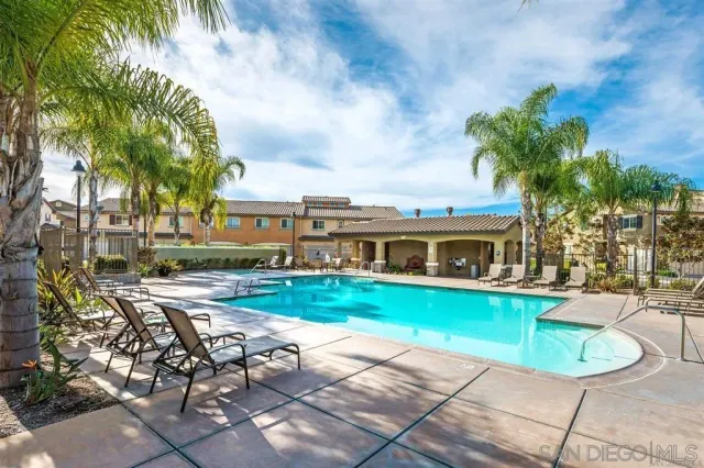 a view of a house with swimming pool and sitting area