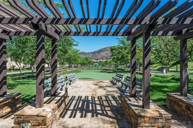 a backyard of a house with a garden and outdoor seating
