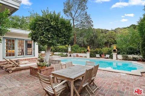 a backyard of a house with table and chairs