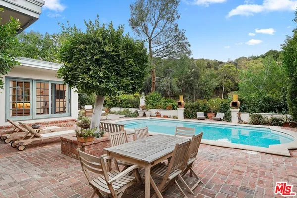 a backyard of a house with table and chairs