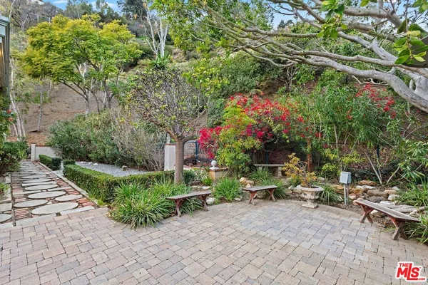 a backyard of a house with a tree and sitting area