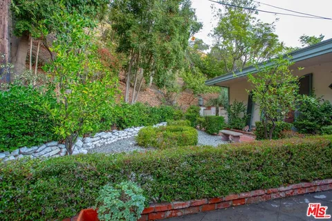 a view of a backyard with sitting area