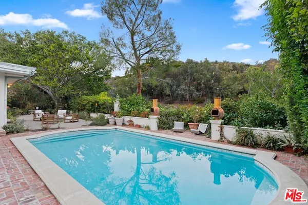 a view of a swimming pool with lounge chair