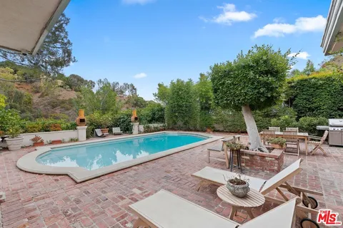 a view of a swimming pool with chairs