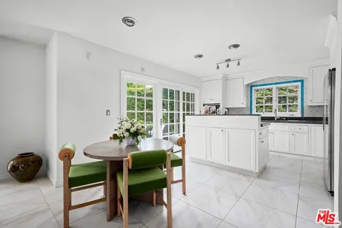 a kitchen with a cabinets and chairs