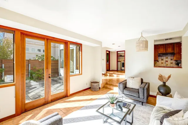 a living room with furniture a rug and white walls