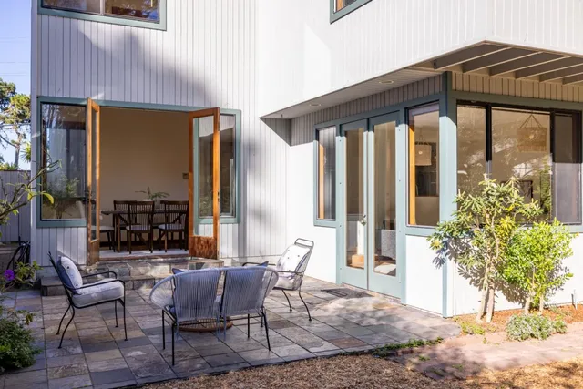 a view of a patio with table and chairs and potted plants