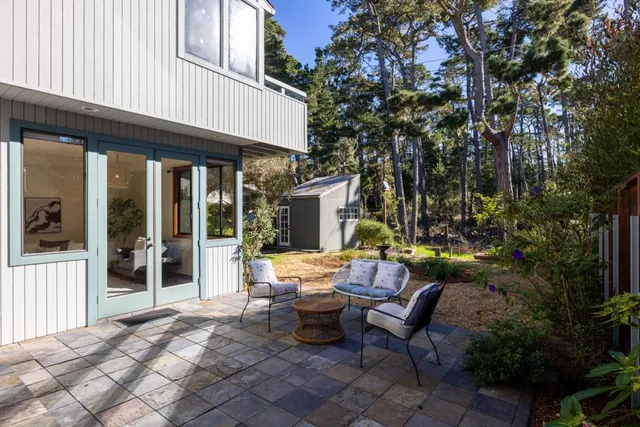 a view of a house with backyard porch and sitting area