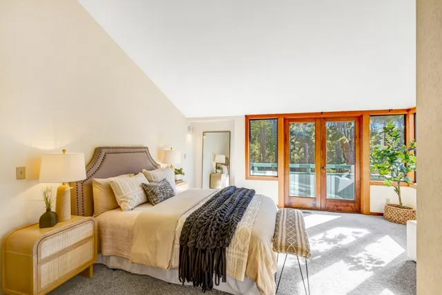 a bedroom with a bed and a large window