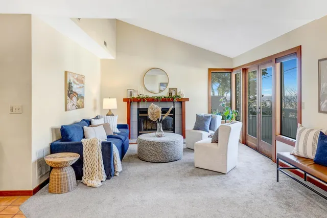 a living room with furniture a flat screen tv and a large window