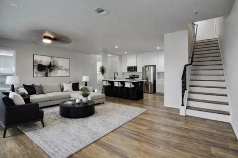 a living room with furniture and kitchen view