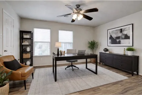 a living room with furniture a table and a large window
