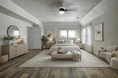 a spacious bedroom with a bed and a dresser