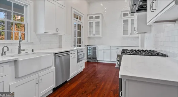 a view of a kitchen with white cabinets