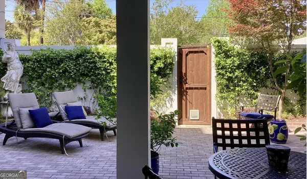 a view of a yard with flower plants