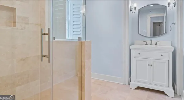 a bedroom with a bed and a closet with mirror